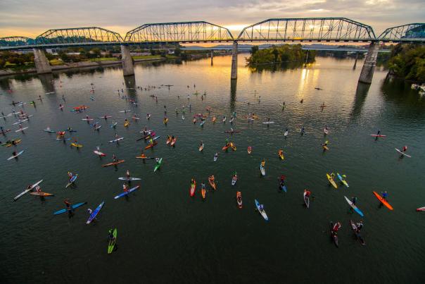 Aerial image of Tennessee River and Walnut Street bridge at sun rise with paddleboards all across the river for Chattajack event