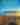 The Scenic City | Chattanooga Travel Inspiration Magazine 2025 | Magazine cover shows person sitting on mountain edge with view of sunrise, cloud inversion and another mountain beyond